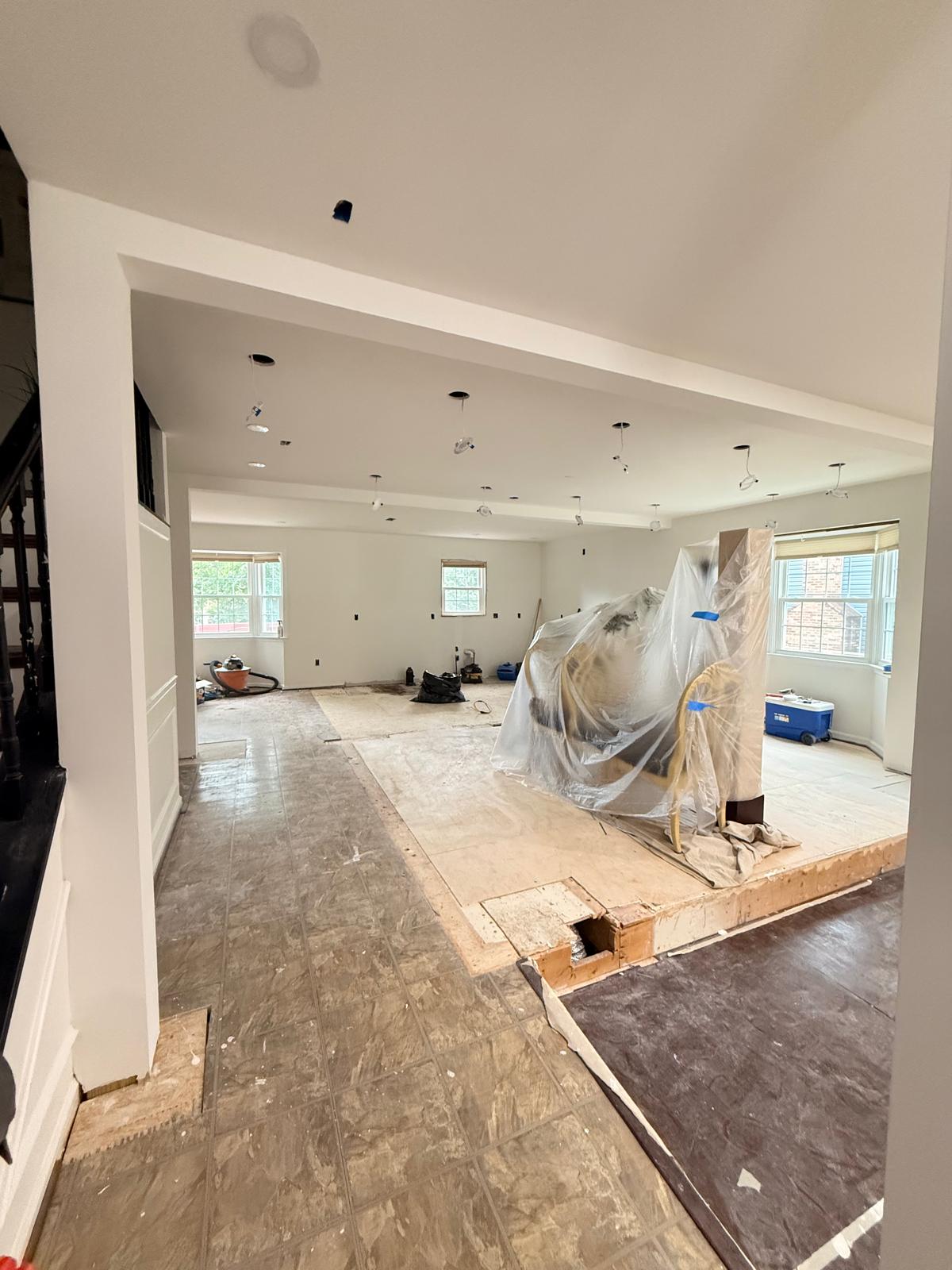 Raised living room platform with new plywood subfloor and recessed ceiling light wiring roughed in
